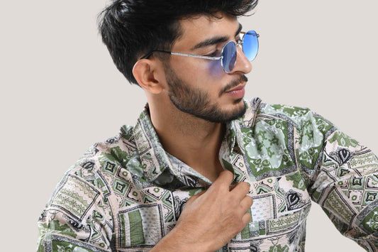 A stylish man wearing a printed shirt with geometric patterns, showcasing the latest trends in men's fashion.