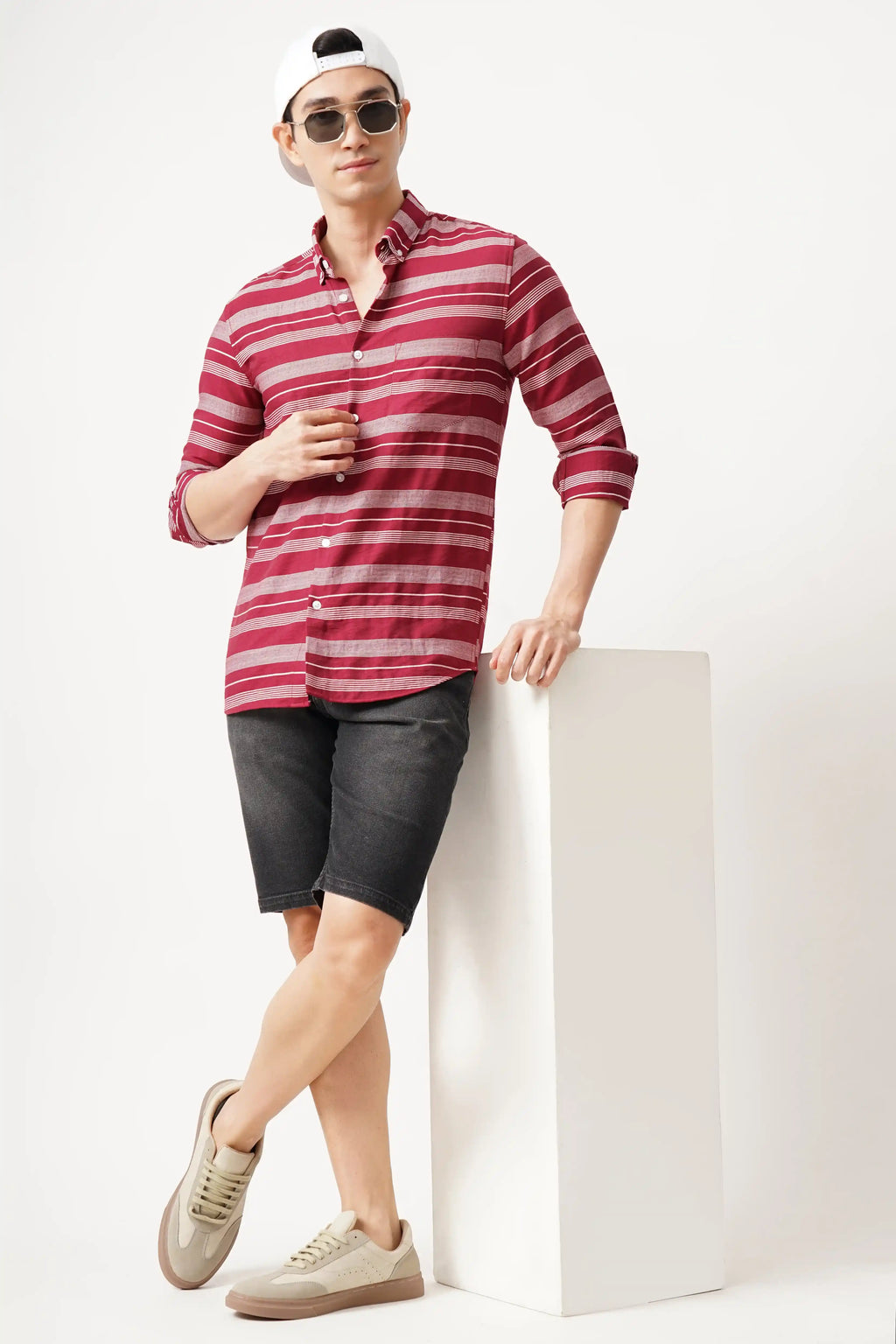 Redune striped shirt in bold red, styled with black shorts and sneakers, perfect for a casual outing.