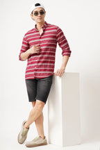 Redune striped shirt in bold red, styled with black shorts and sneakers, perfect for a casual outing.
