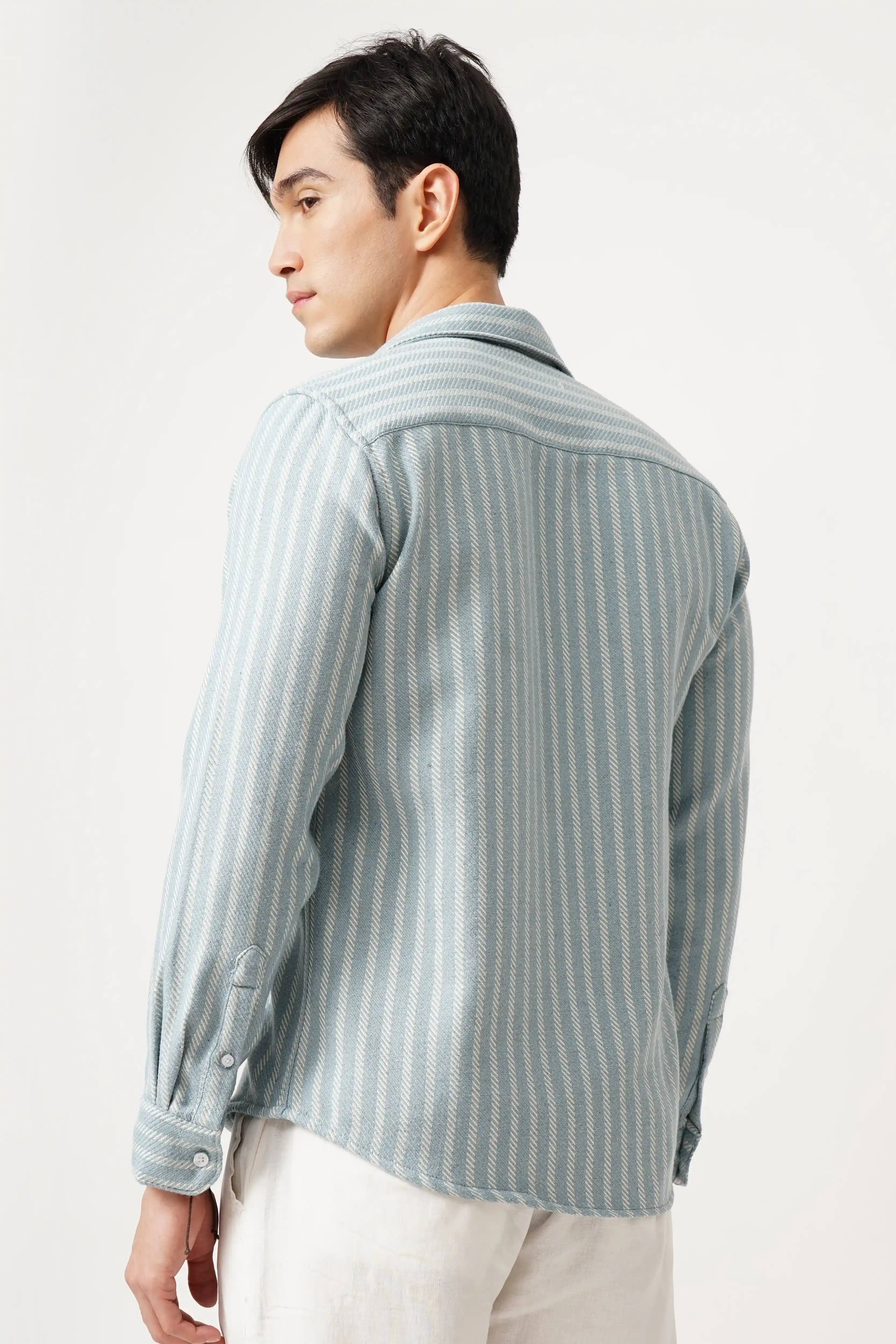 Man wearing Aqualure striped shirt, back view, showcasing premium brush fabric and relaxed fit design.