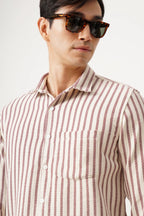 Man wearing Striluxe striped shirt with sunglasses, featuring a tailored silhouette and premium brush fabric.