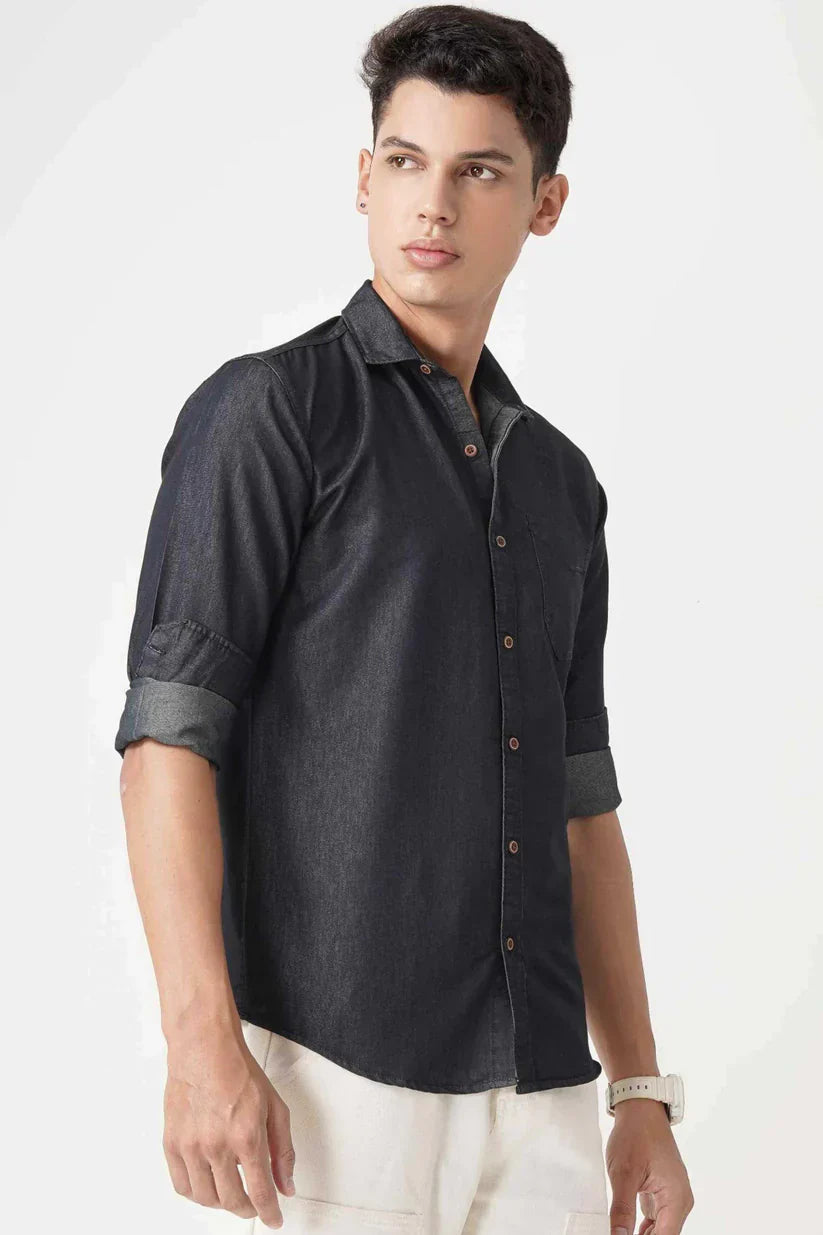 Men's black denim shirt made from cotton fabric, offering comfort and style.