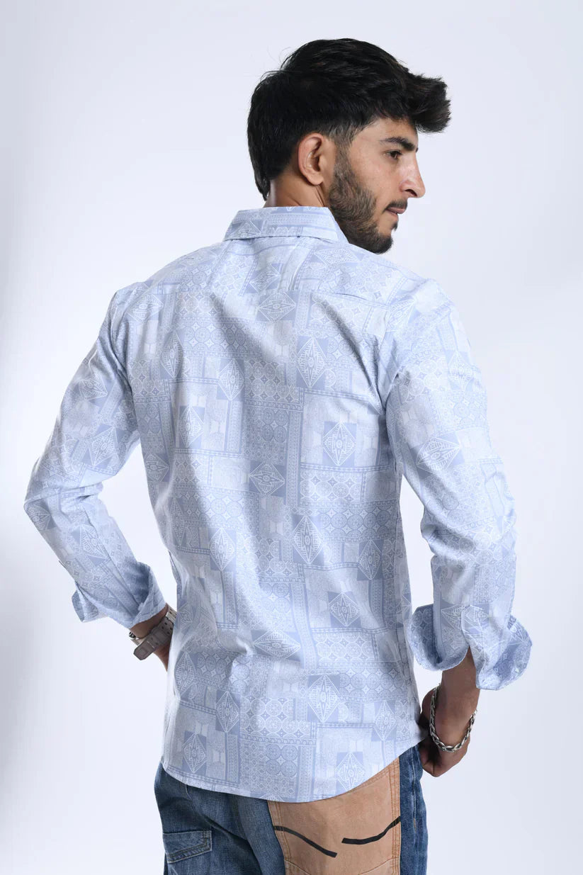 Man wearing a blue geometric pattern shirt made from cotton blend lycra fabric.