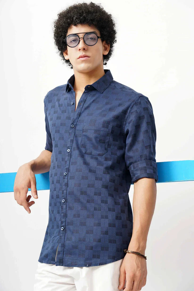 Man wearing a stylish dark blue jacquard shirt with classic design.