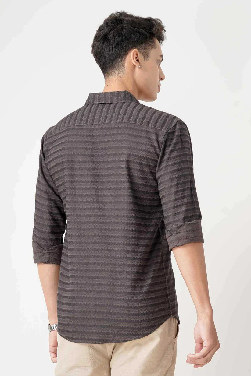 Man wearing a brownish striped shirt made with ultra-soft fabric.