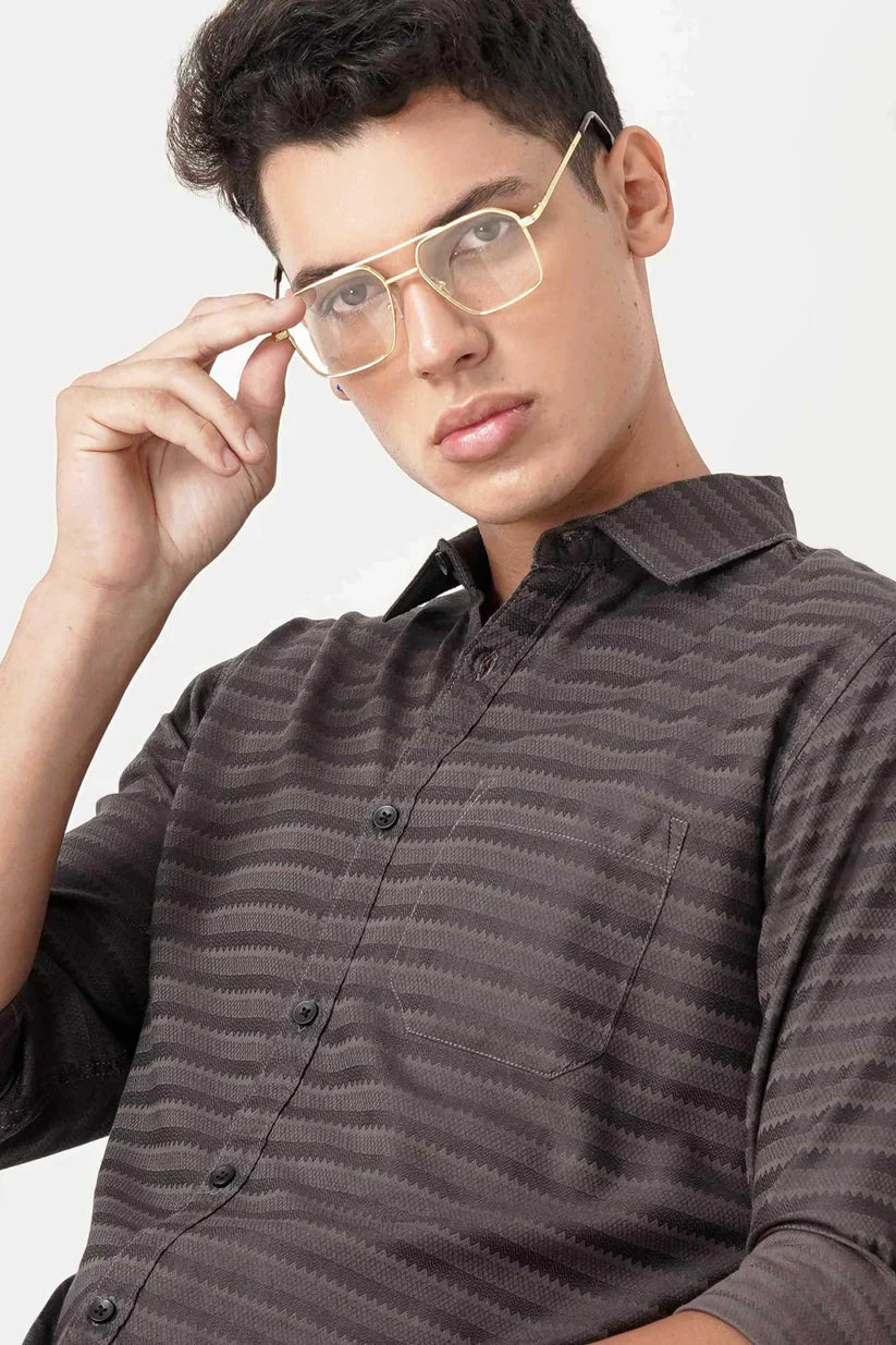 Man wearing a brownish striped shirt made with ultra-soft fabric.