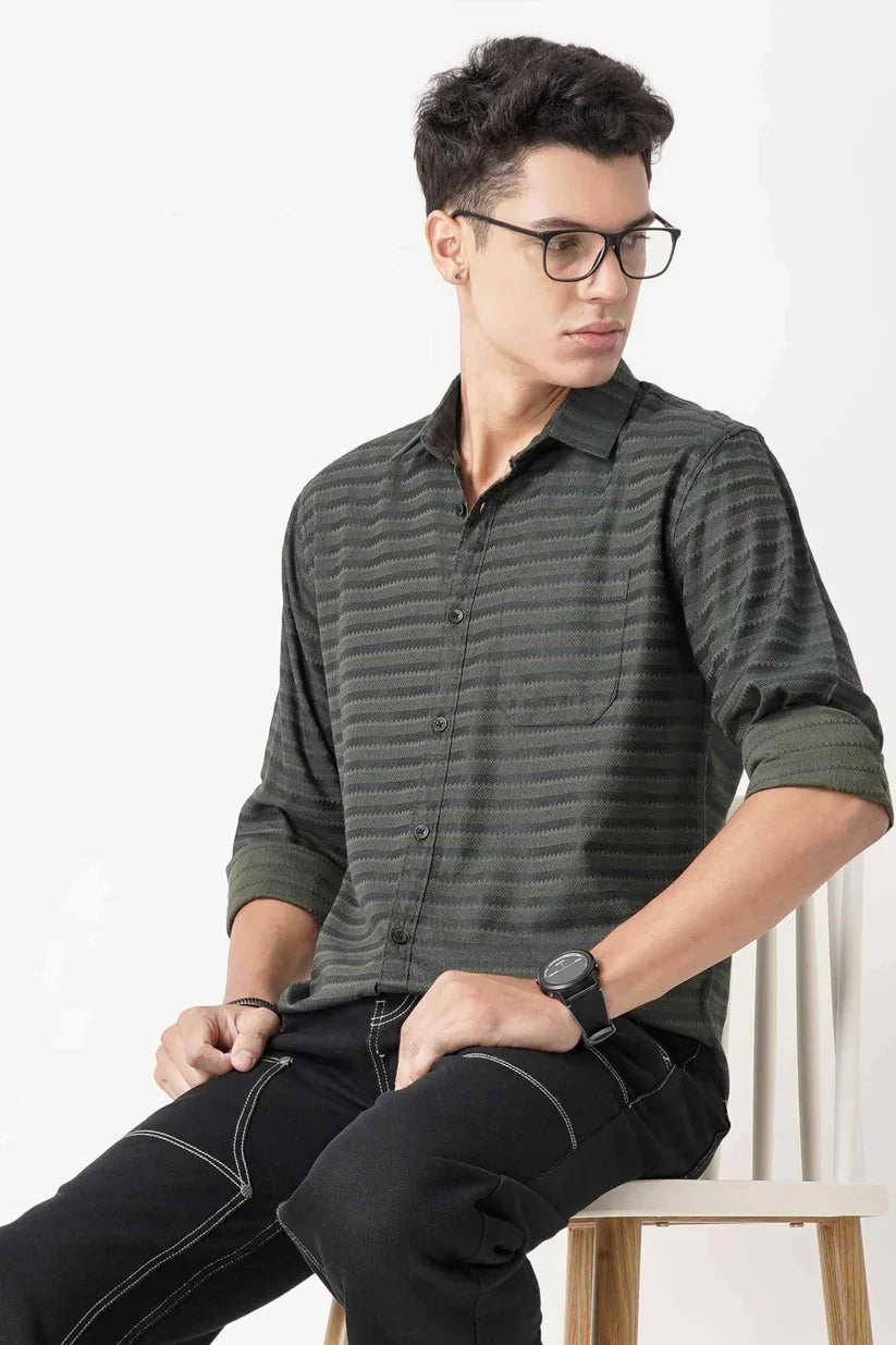 Man wearing a stylish dark green striped shirt made of ultra-soft 100% cotton.