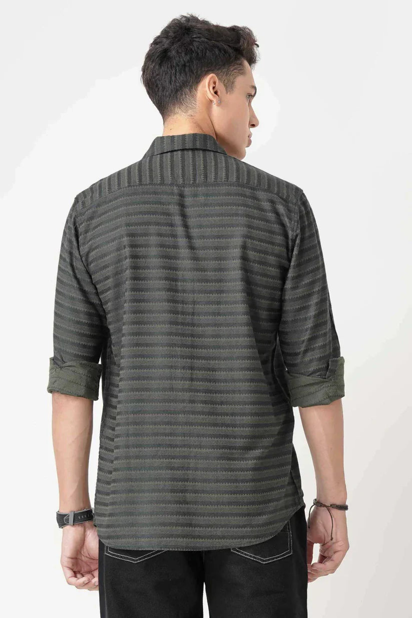 Male wearing dark green striped shirt, 100% cotton, back view.