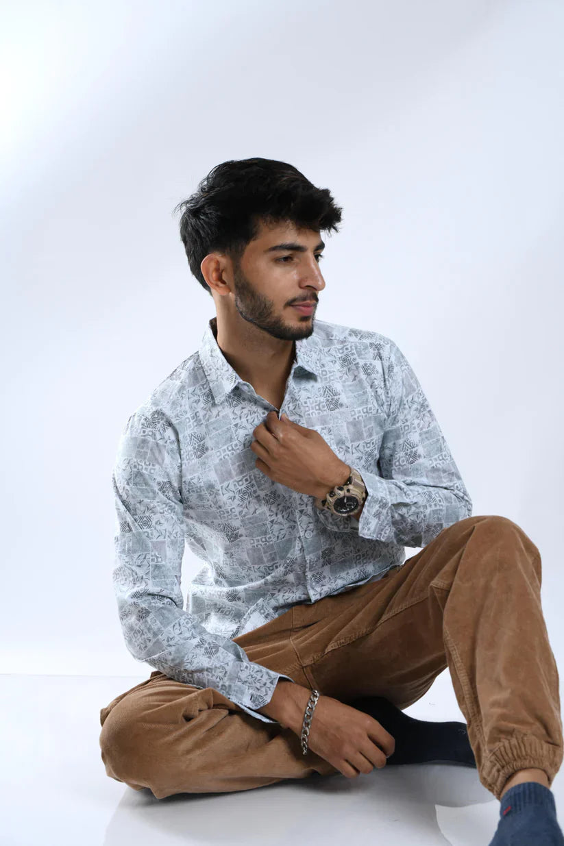 Man wearing a flower green printed shirt made from 100% cotton fabric.