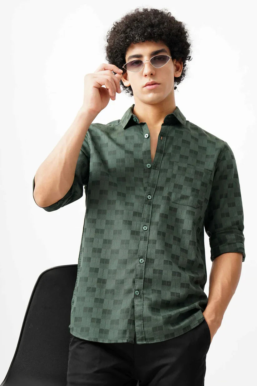 Male model wearing a green jacquard shirt.