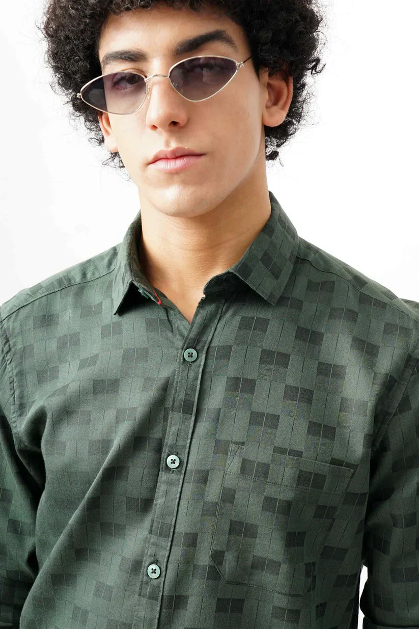 Man wearing a green jacquard shirt with classic design.