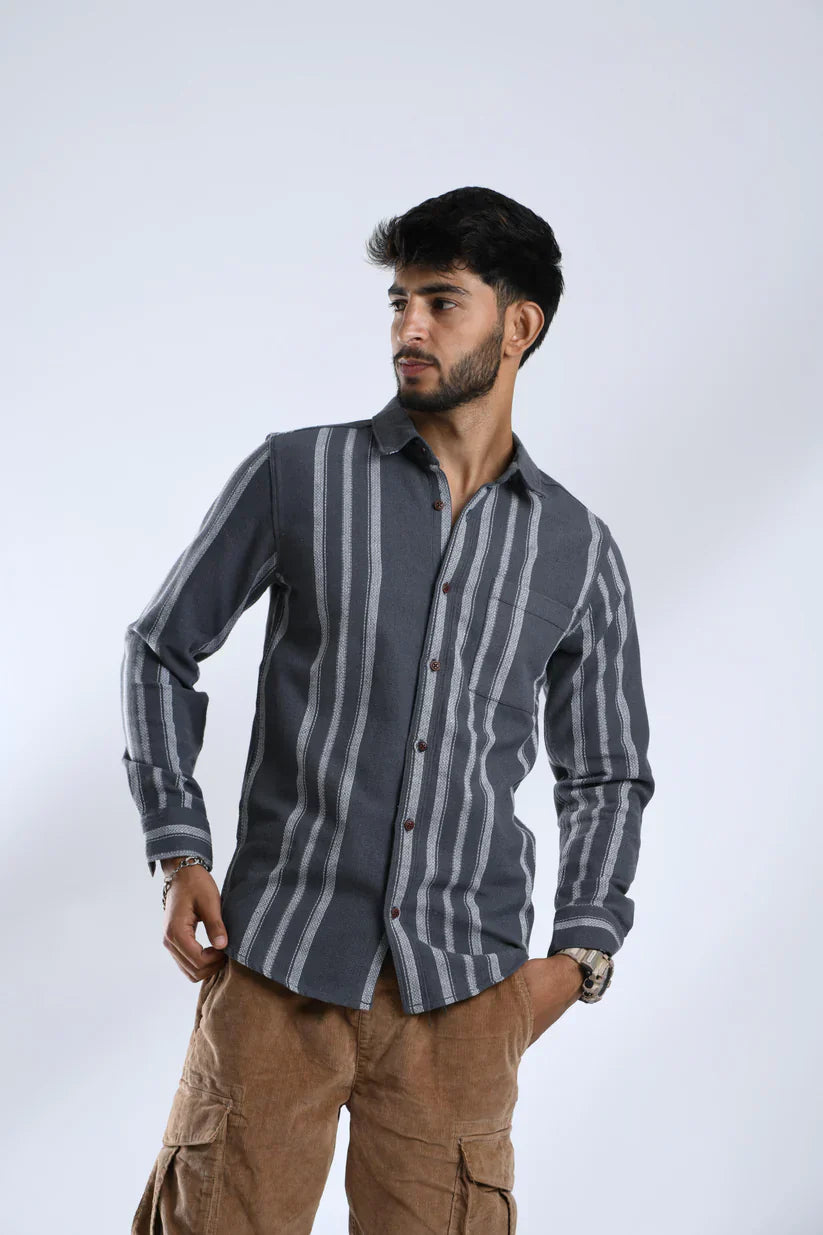 Man wearing a grey white striped shirt in cotton fabric.