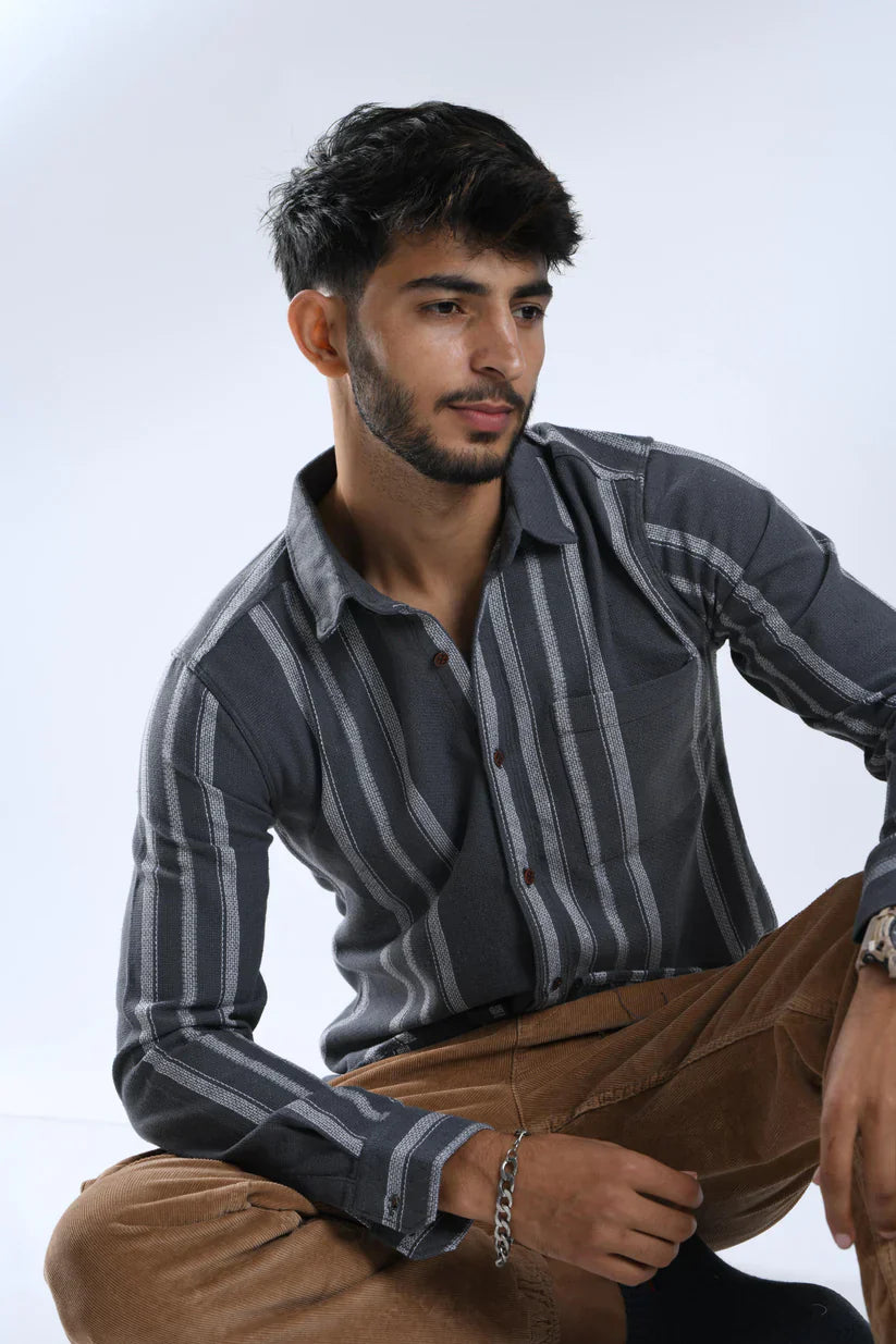 Male model wearing a grey white striped shirt made from cotton fabric.