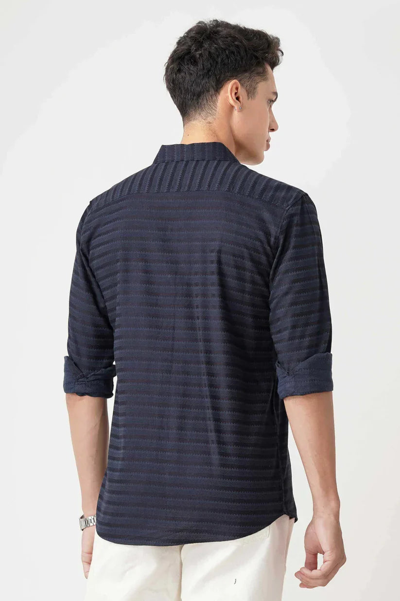 Navy blue striped shirt made with cotton blend fabric, seen from the back.