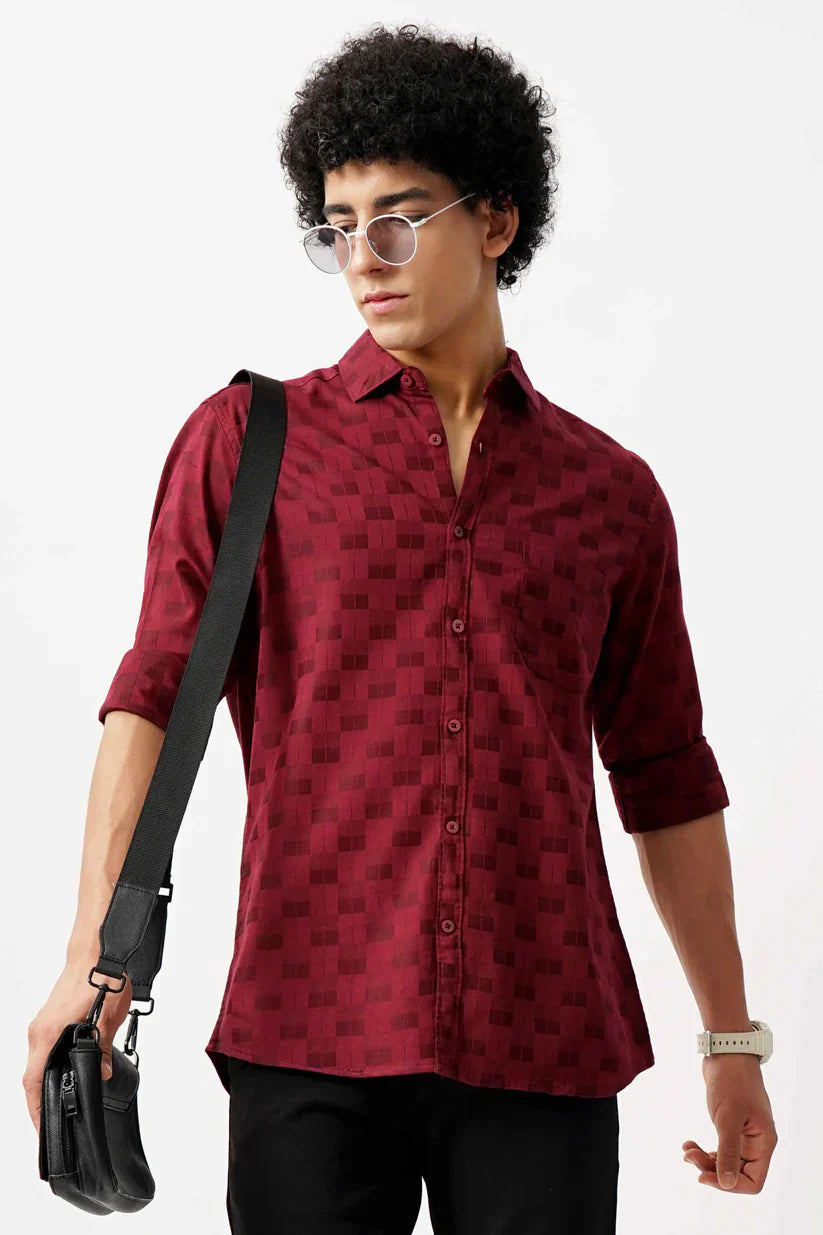 Man wearing a stylish red jacquard shirt with classic design.