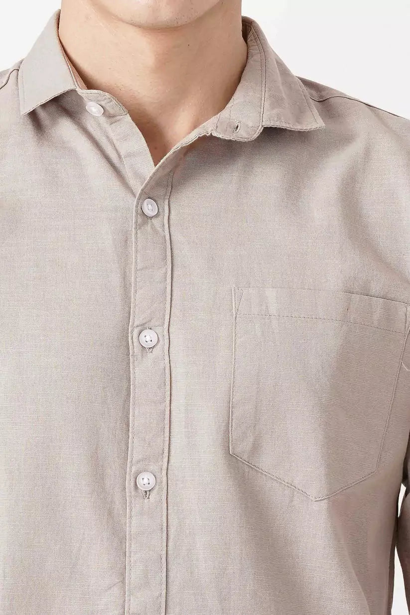 Beige linen shirt with button-up front and chest pocket.