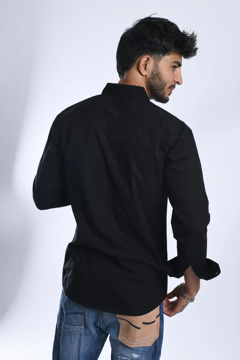 Man wearing a black velvet plain shirt made of 100% cotton.