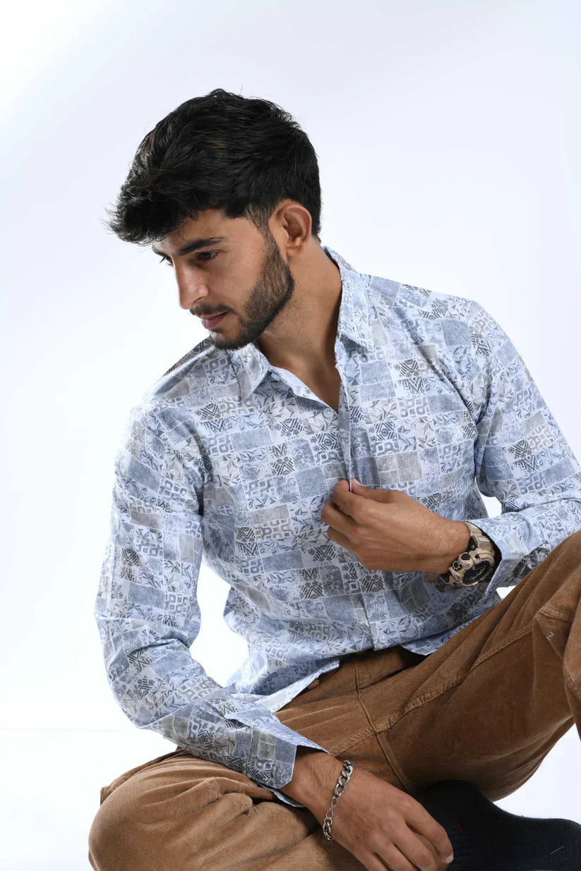 Man wearing elegant blue floral printed shirt, stylish and comfortable.