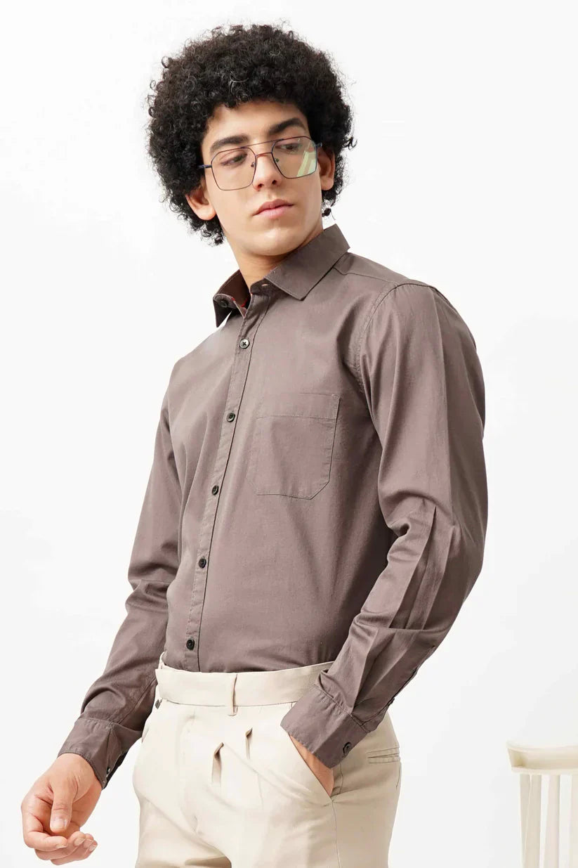 Man wearing a brown minimalist shirt made of 100% cotton.