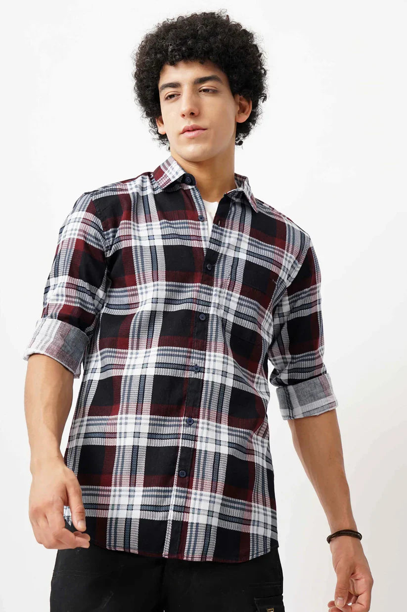 Man wearing a maroon grid shirt made with cotton mix fabric.