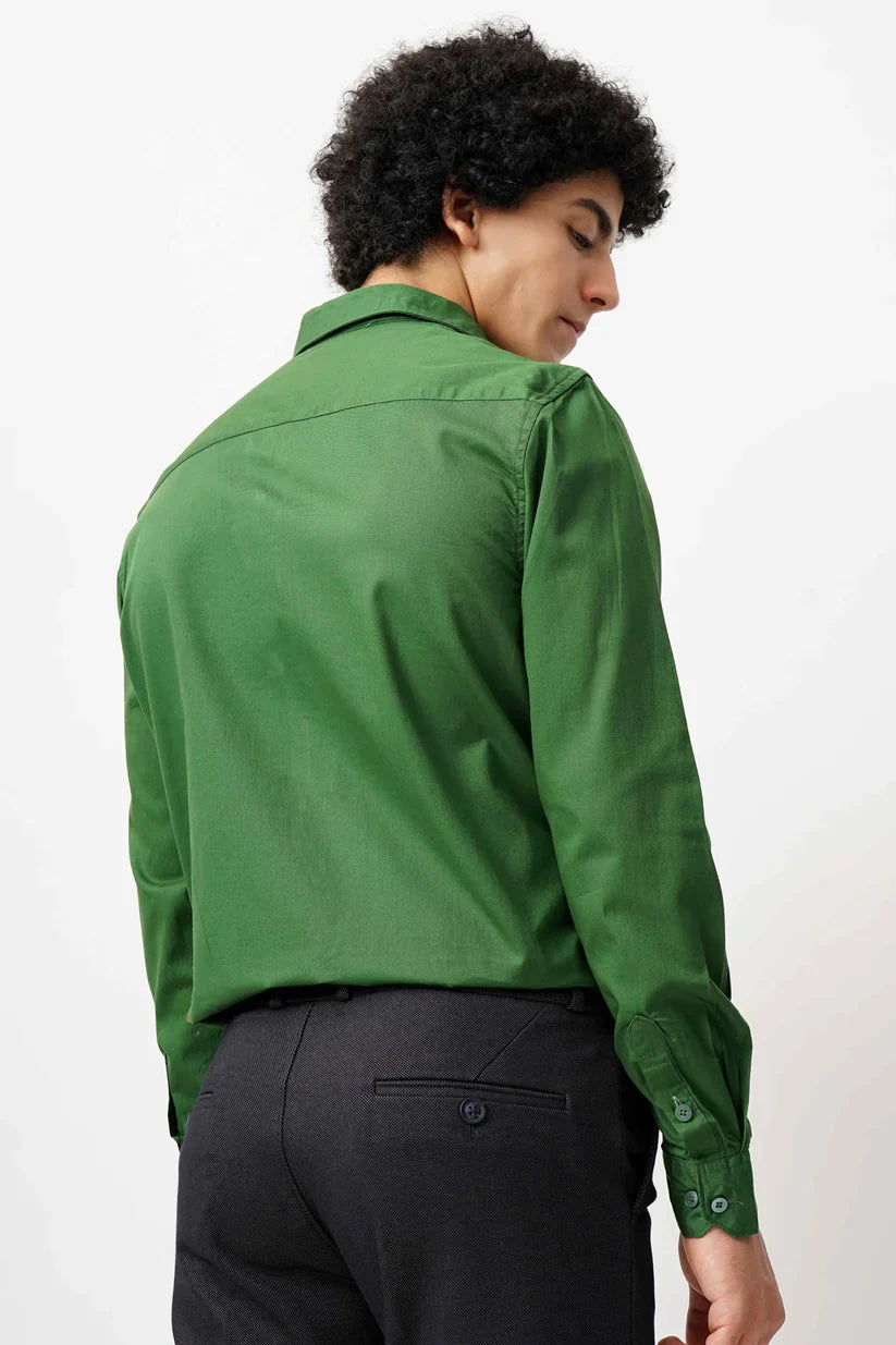 Man wearing green minimalist shirt made with 100% cotton.