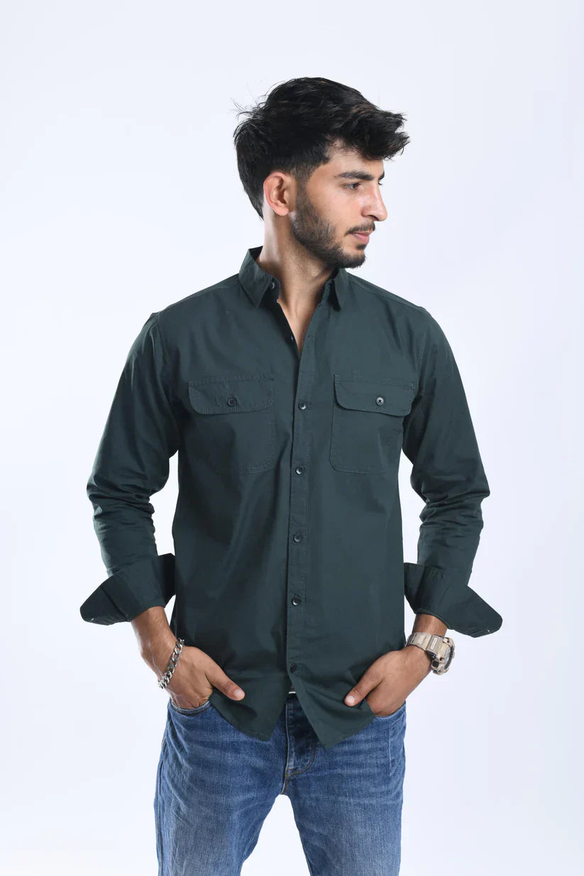 Man wearing a classic green plain shirt made from 100% cotton.