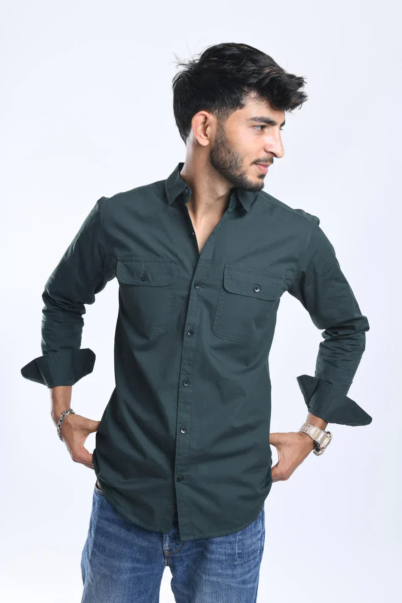 Man wearing a green plain shirt made of 100% cotton.