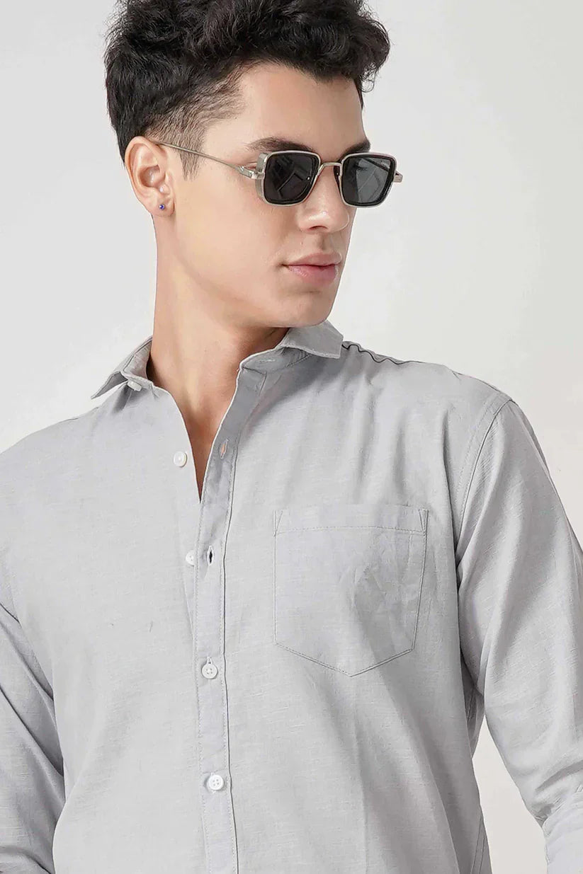 Man wearing an ice blue linen shirt.