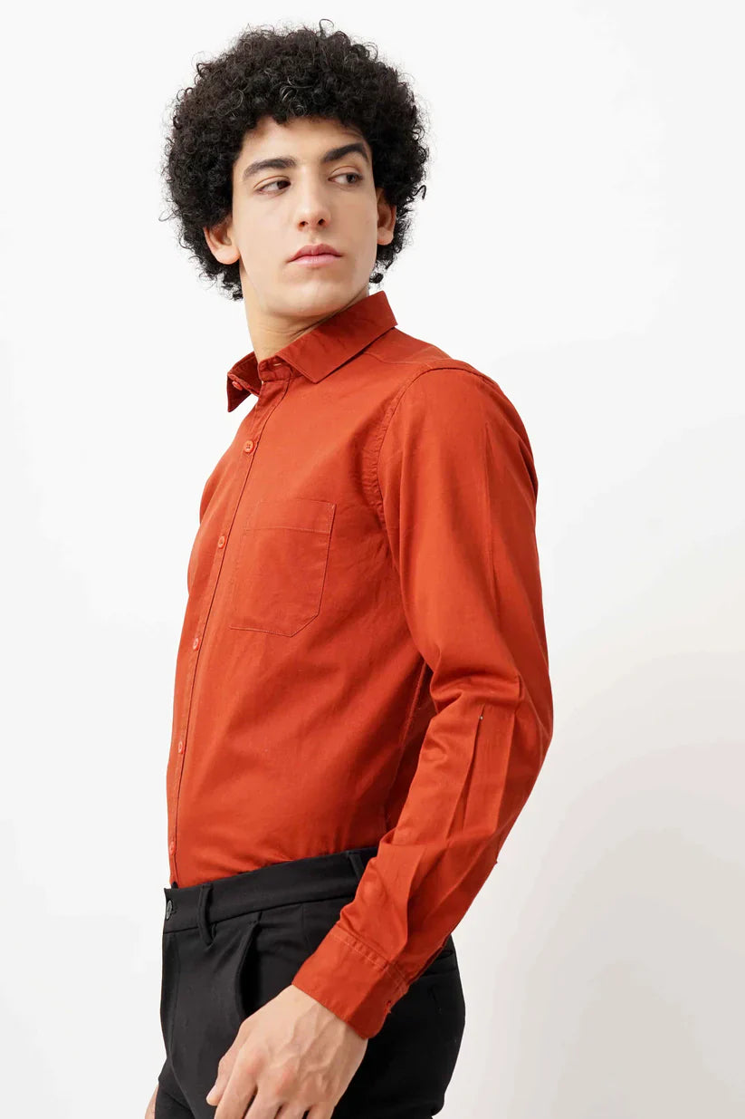 Man wearing maroon minimalist shirt made of 100% cotton.