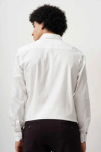 Back view of a man wearing a white minimalist cotton shirt.