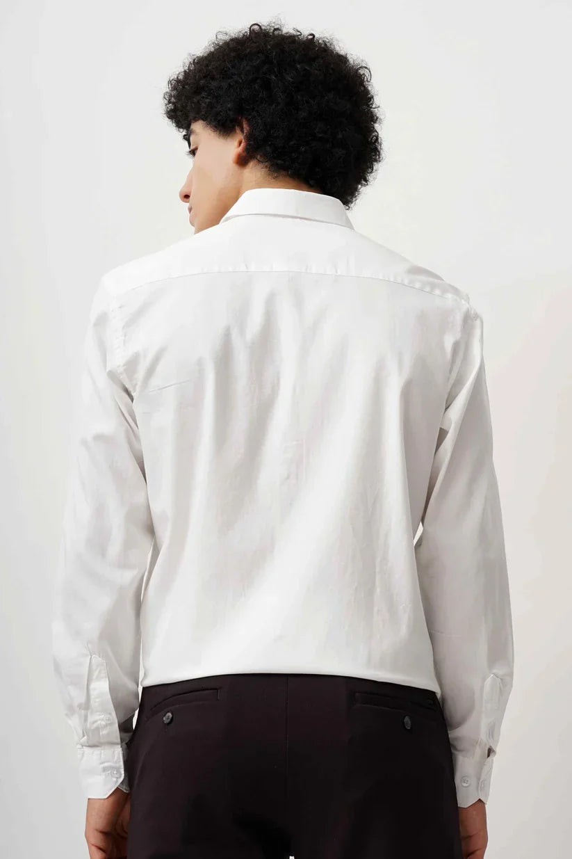 Back view of a man wearing a white minimalist cotton shirt.